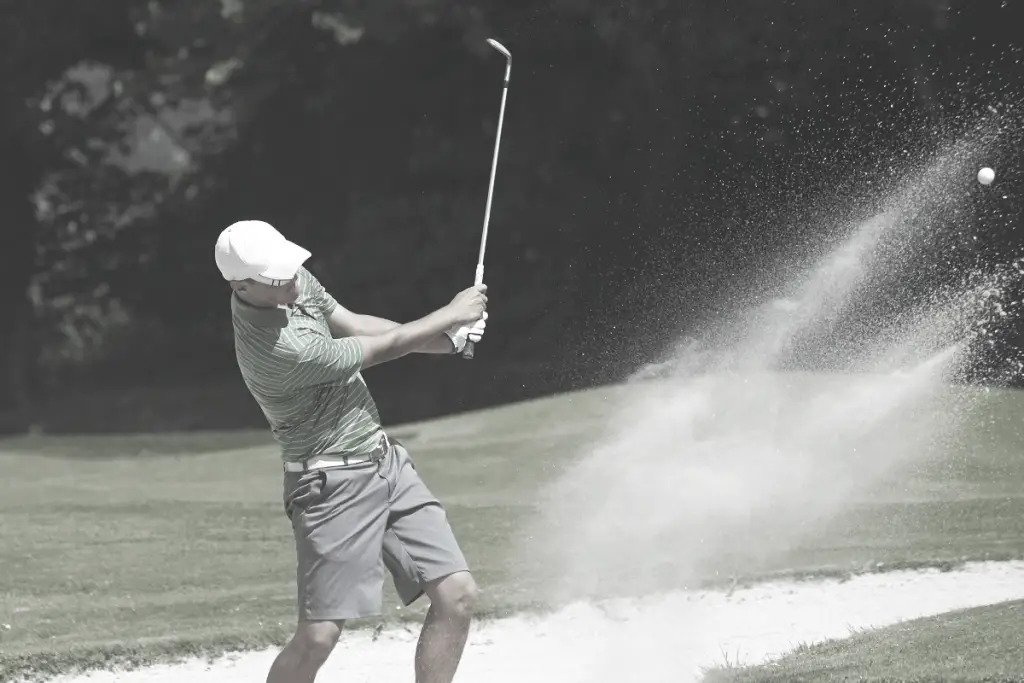 golfer hitting sand wedge from a bunker