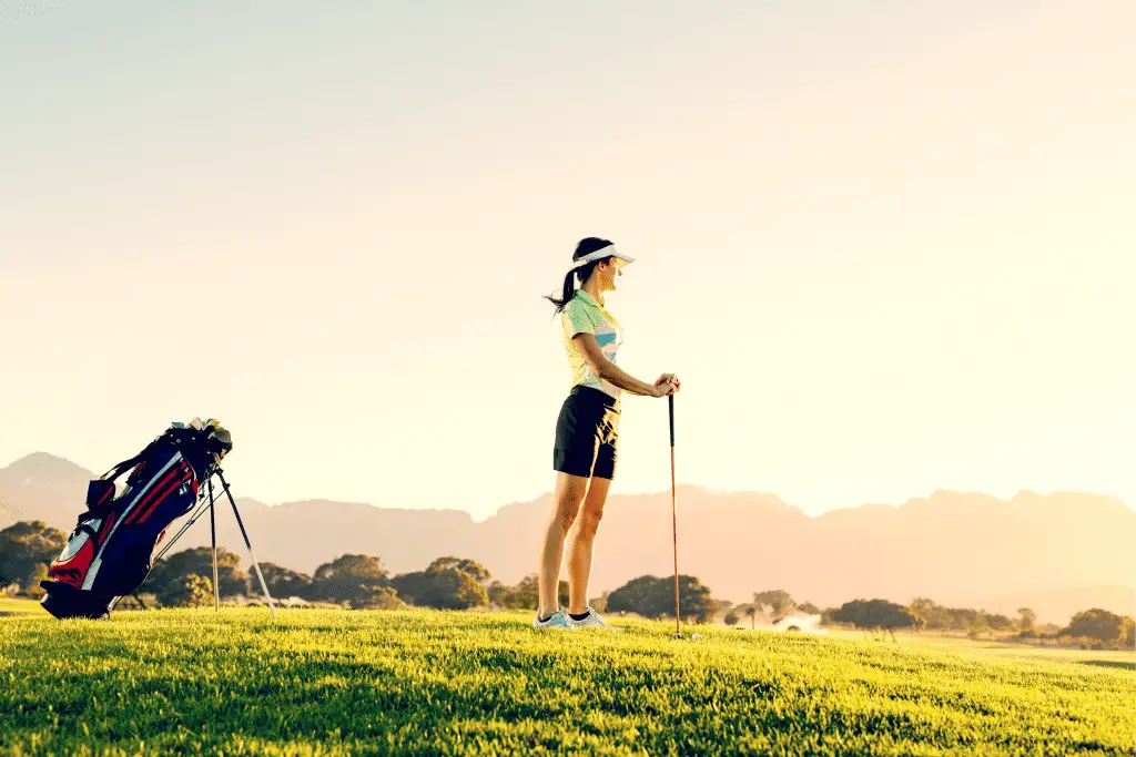 Woman on Tee with Golf Bag