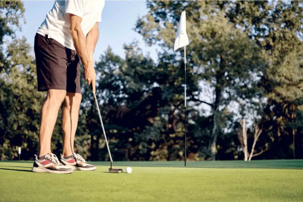 Golfer putting on the green