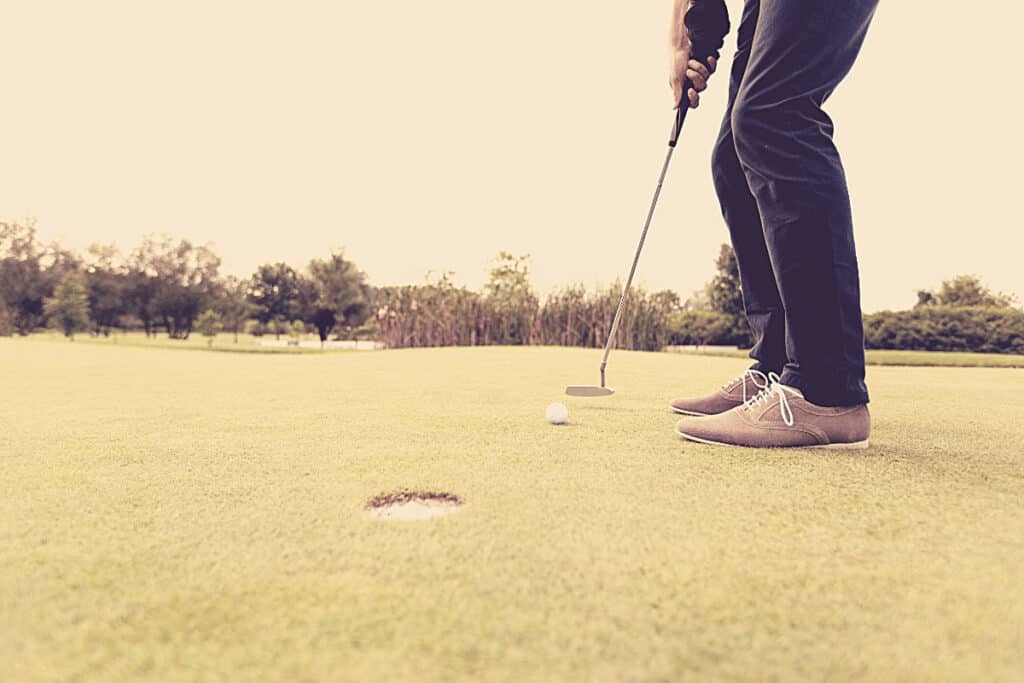 Golfer in Skechers Shoes Putting on the Green