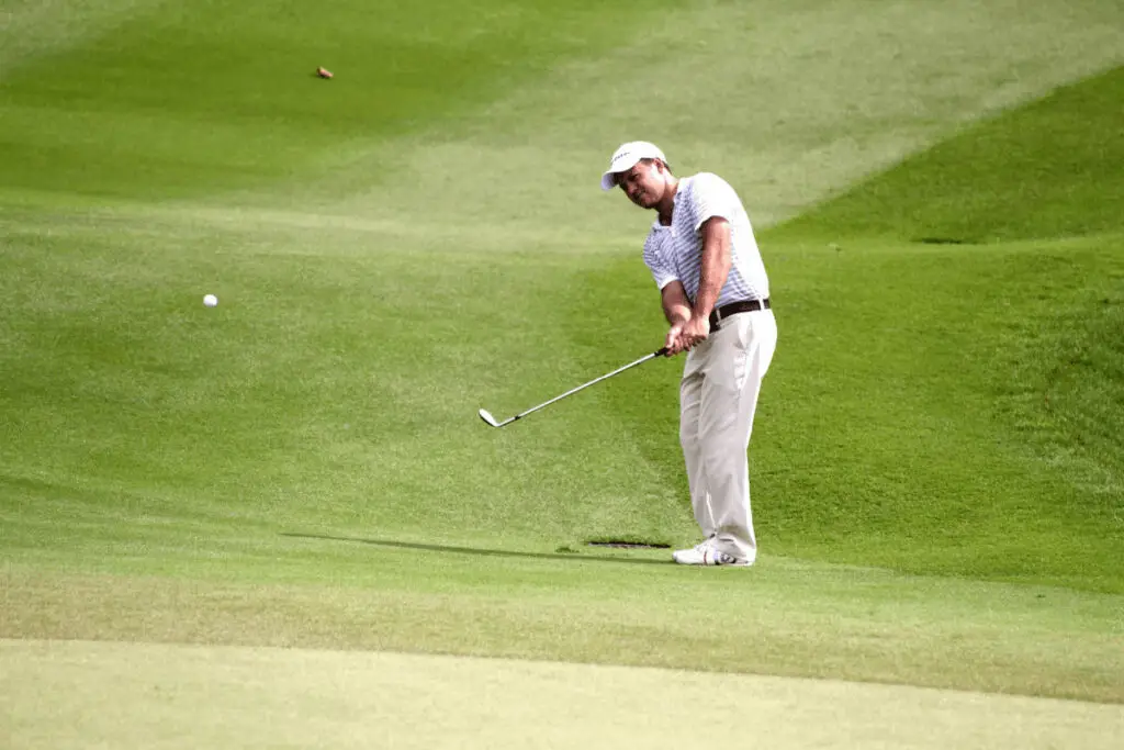 golfer chipping with Srixon iron