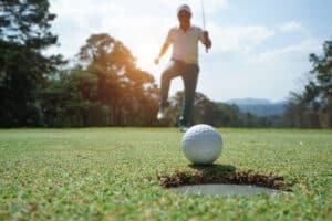 Golfer Making a Putt on the Green